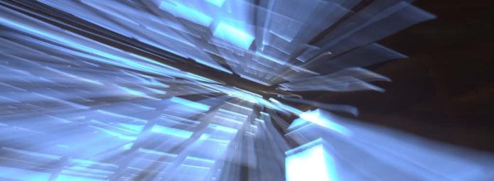 Abstract image featuring streaks of blue light radiating from the center against a dark background, creating a dynamic, energetic effect.