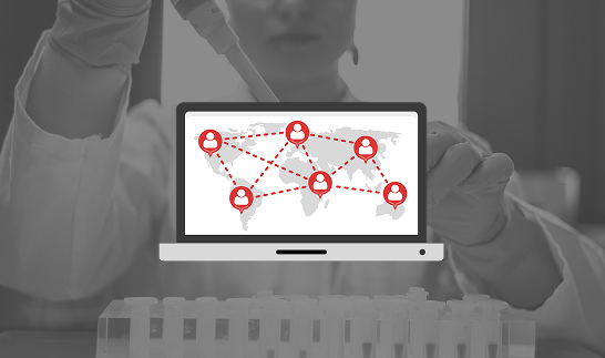 A scientist in a lab coat uses a pipette above test tubes. A transparent laptop graphic overlays the image, displaying a world map with red user icons connected by dashed lines, suggesting global communication or collaboration.